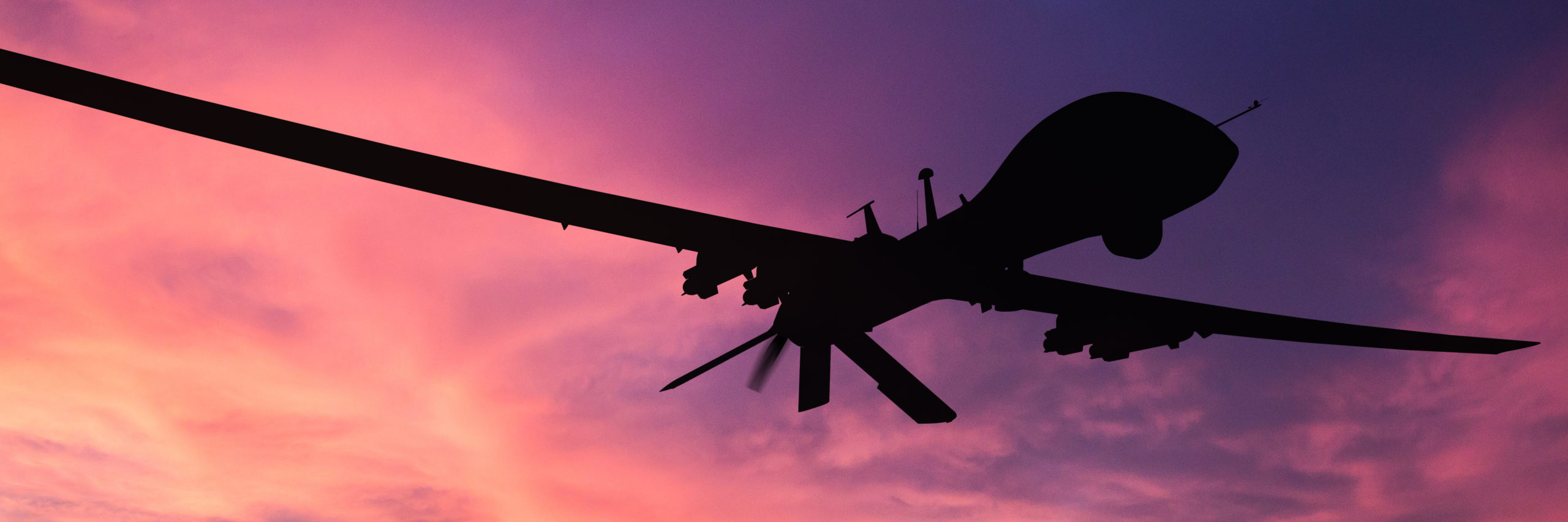 Military drone silhouette on sunset background. - Image [shutterstock]