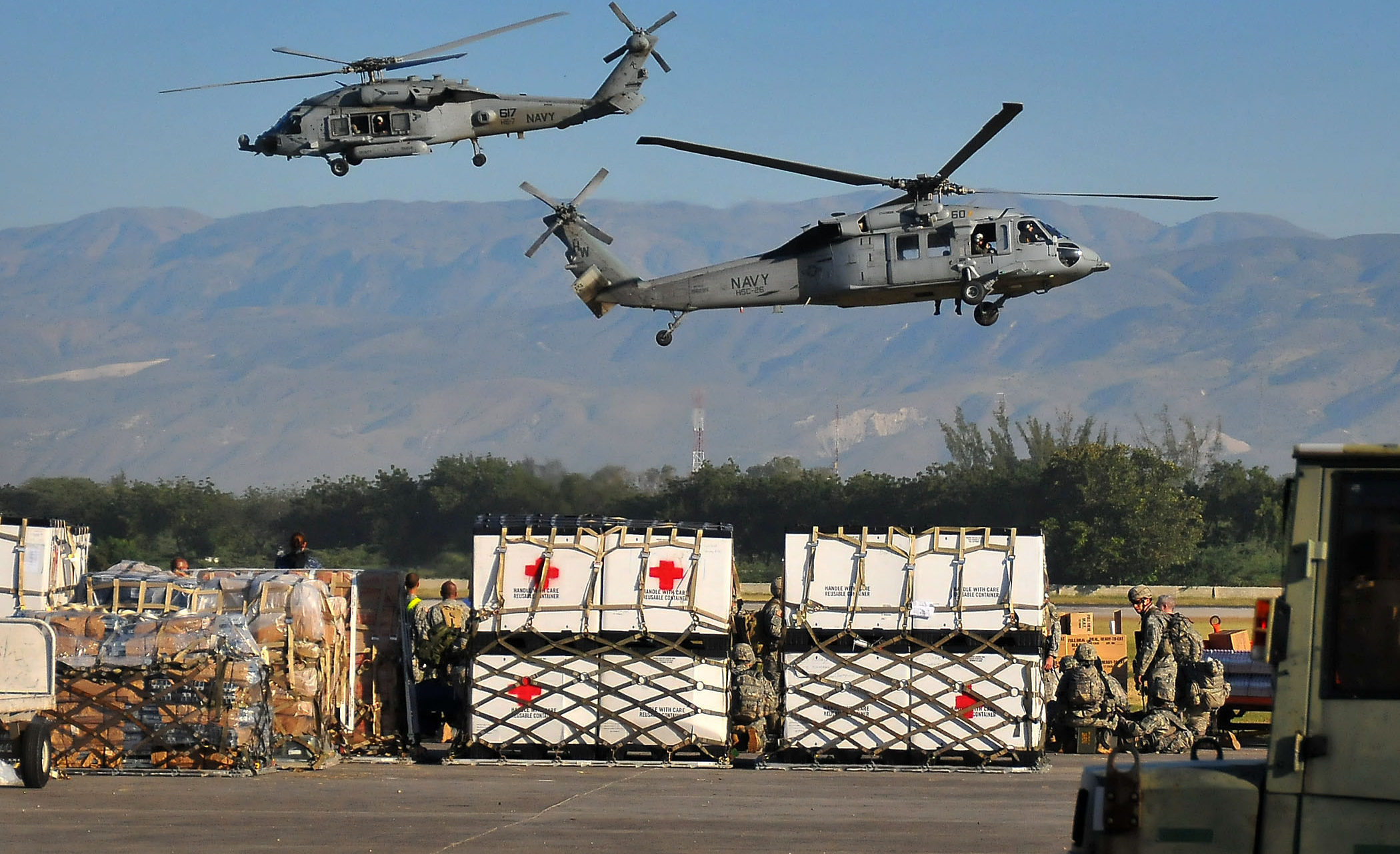 PORT-AU-PRINCE, Haiti  (Jan. 18, 2010) U.S. Navy SH-60F Sea Hawk helicopters from the Nimitz-class aircraft carrier USS Carl Vinson (CVN 70) transport water and supplies from the airport to areas around Port-au-Prince. Carl Vinson and Carrier Air Wing (CVW) 17 are conducting humanitarian and disaster relief operations as part of Operation Unified Response after a 7.0 magnitude earthquake caused severe damage near Port-au-Prince on Jan. 12, 2010. (U.S. Navy photo by Mass Communication Specialist 2nd Class Daniel Barker/Released)