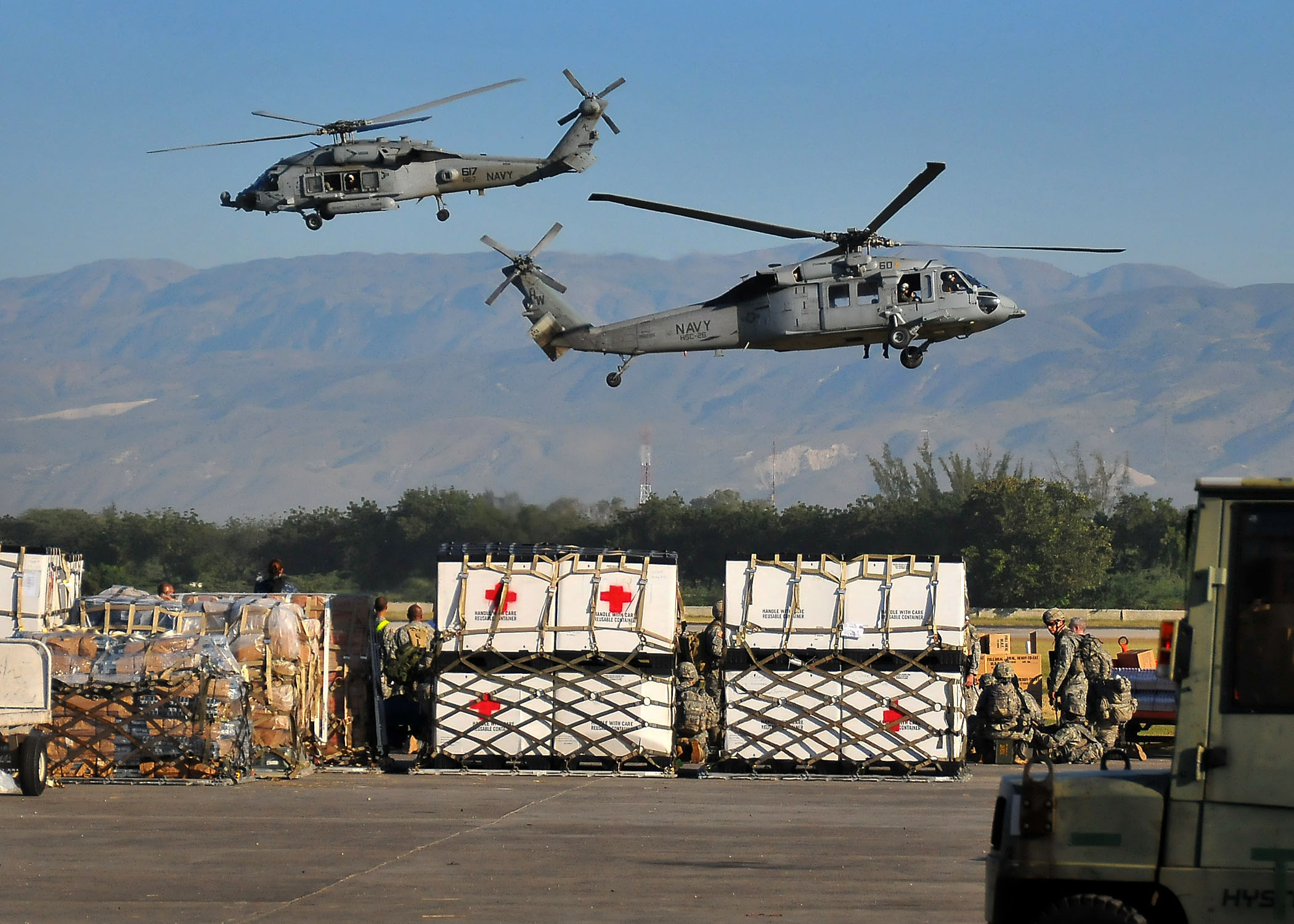 PORT-AU-PRINCE, Haiti  (Jan. 18, 2010) U.S. Navy SH-60F Sea Hawk helicopters from the Nimitz-class aircraft carrier USS Carl Vinson (CVN 70) transport water and supplies from the airport to areas around Port-au-Prince. Carl Vinson and Carrier Air Wing (CVW) 17 are conducting humanitarian and disaster relief operations as part of Operation Unified Response after a 7.0 magnitude earthquake caused severe damage near Port-au-Prince on Jan. 12, 2010. (U.S. Navy photo by Mass Communication Specialist 2nd Class Daniel Barker/Released)