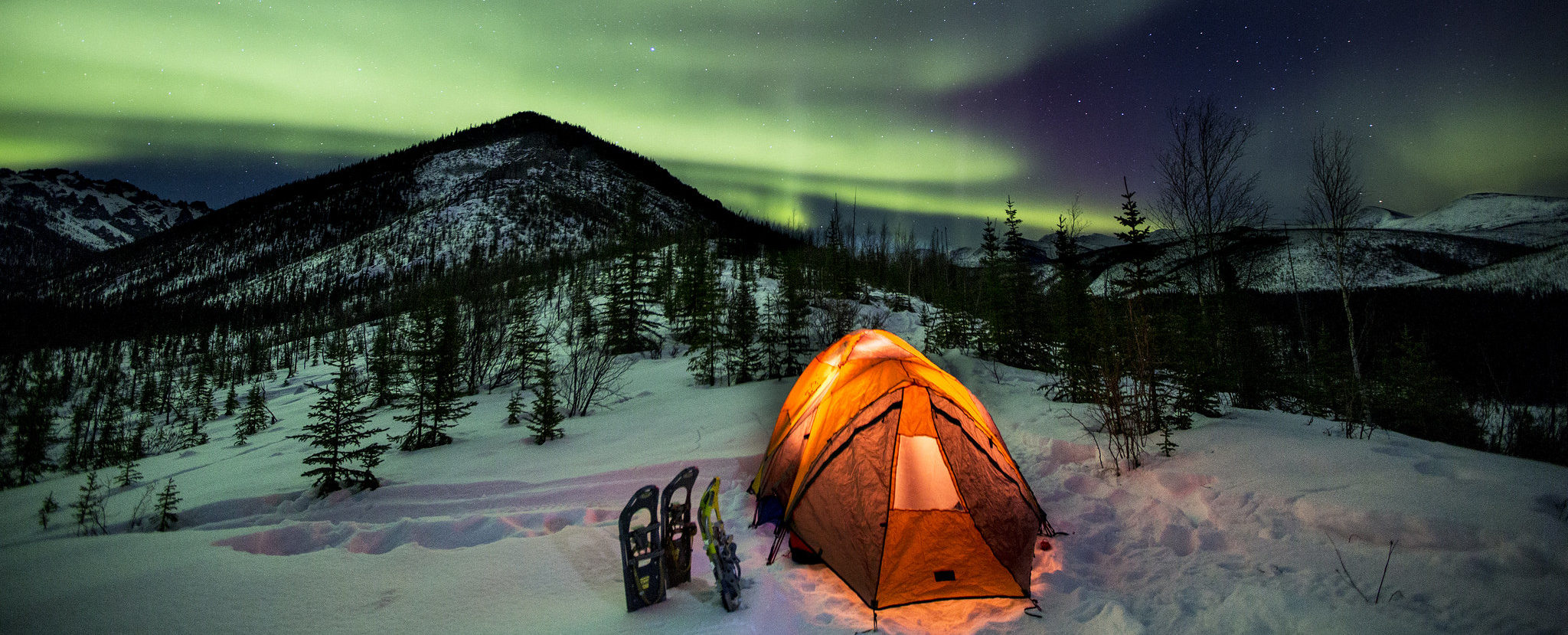 Tent in the snow under the northern lights