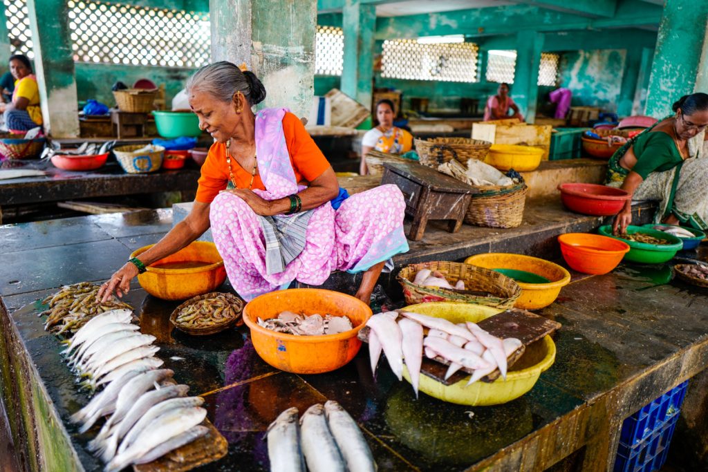 Woman selling fish at a market. (Ishay Botbol; 2015)