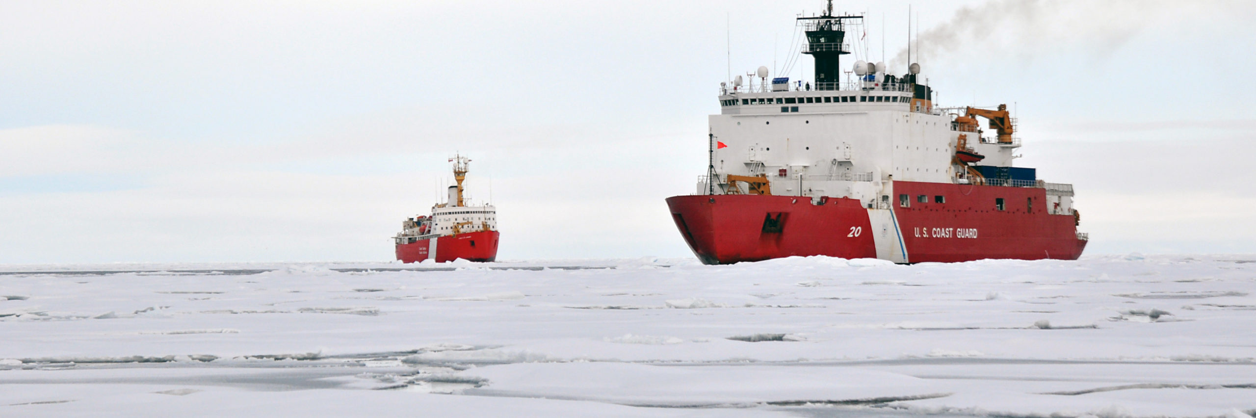 the U.S. Coast Guard Cutter Healy and the Canadian Coast Guard Cutter Louis S Saint Laurent operating in Arctic sea ice, as seen from the ice level