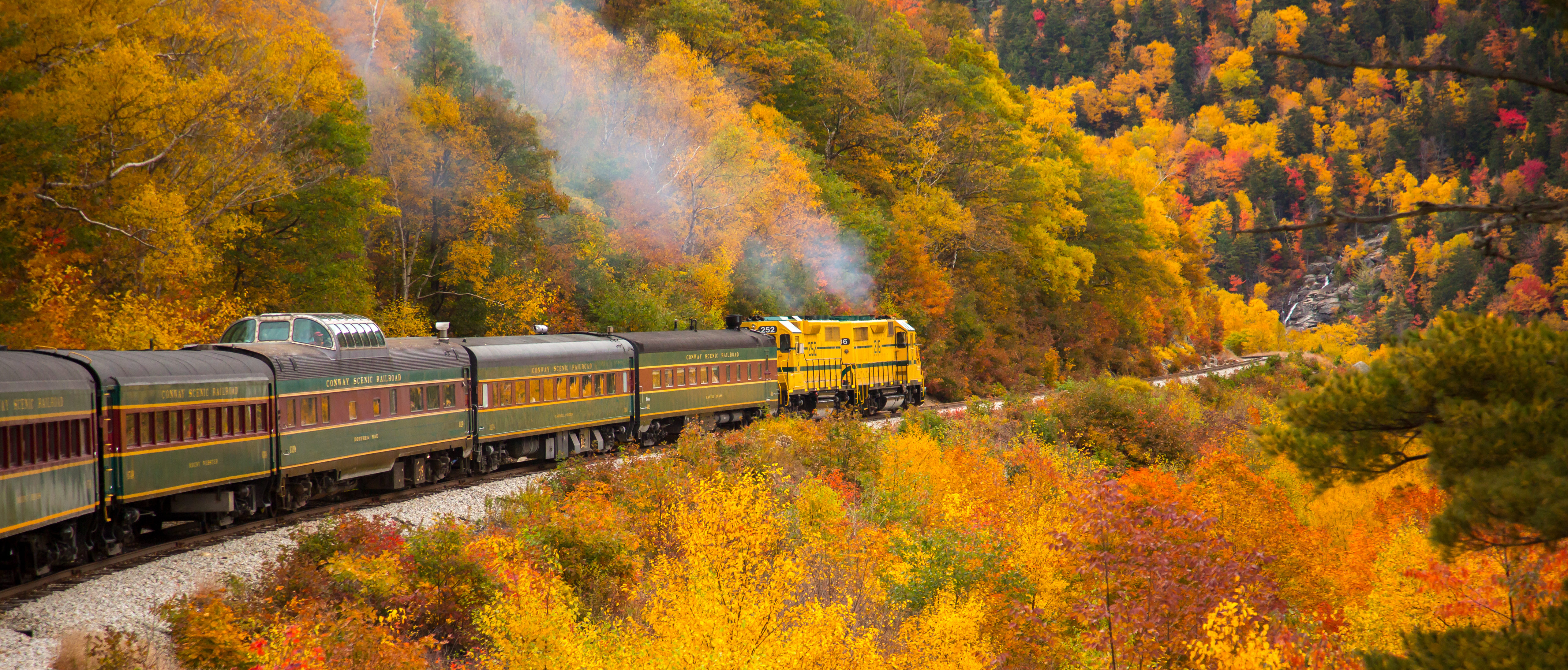 Crawford Notch, New Hampshire - 10/14/2015: The Conway Scenic Railway train just west of Bartlett. Hardwood trees are showing peak fall color in the White Mountain National Forest. - Image