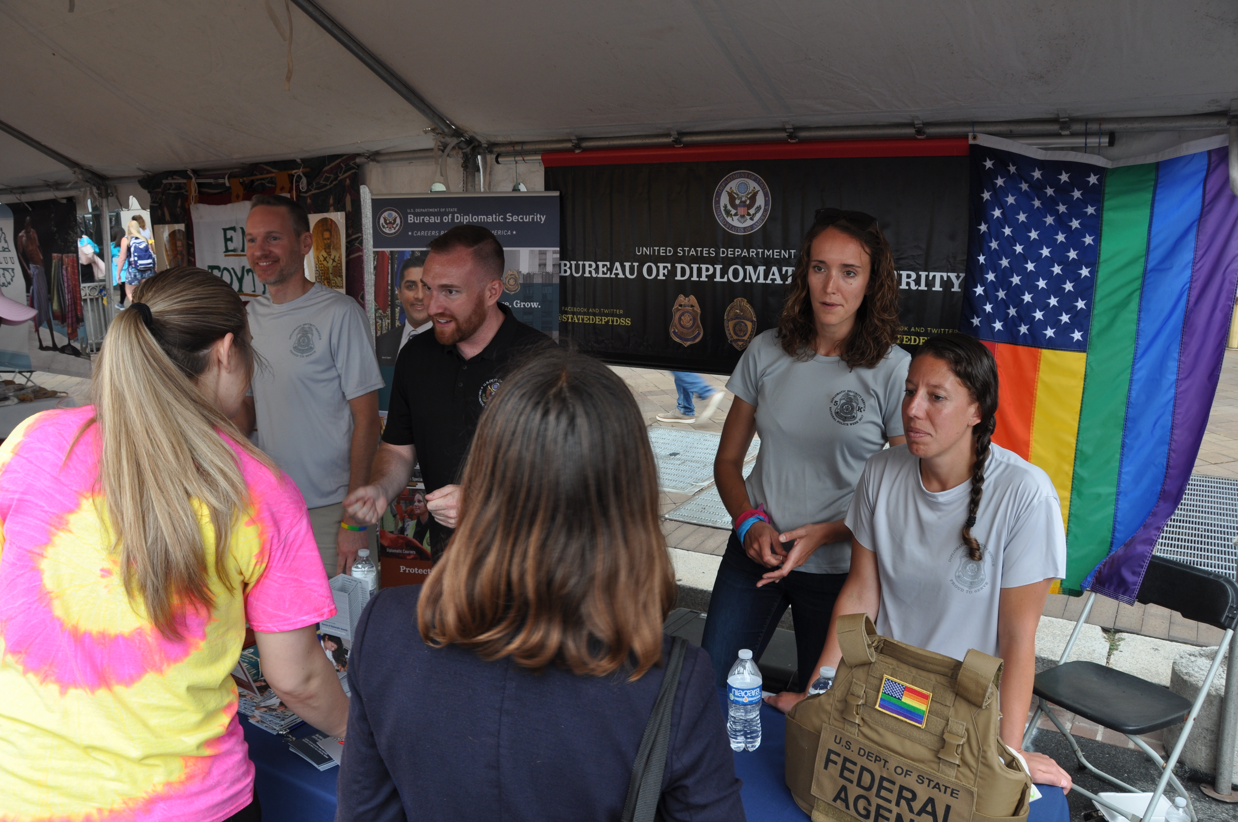DSS personnel engage with attendees at the DSS recruitment booth during the Capital Pride Festival in Washington, D.C., June 9, 2019. (U.S. Department of State photo)