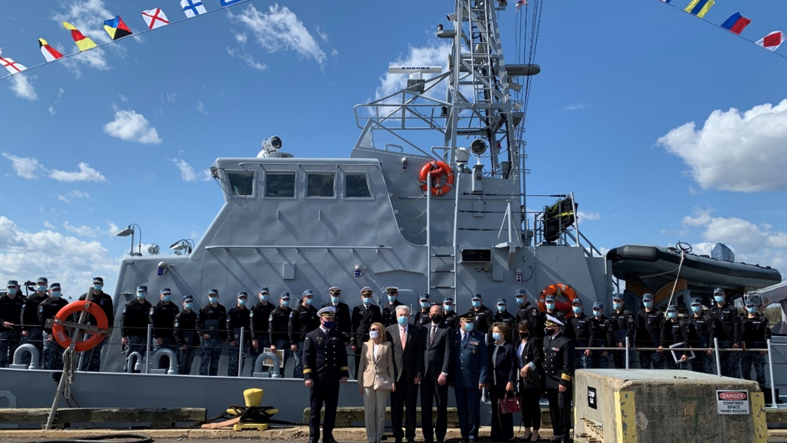Ukrainian naval personnel and their American trainers pose in front of Sumy on graduation day. (Photo courtesy of the U.S. Coast Guard)