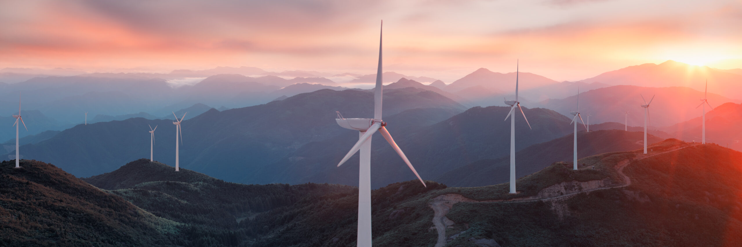 Wind turbines in the hills at sunset