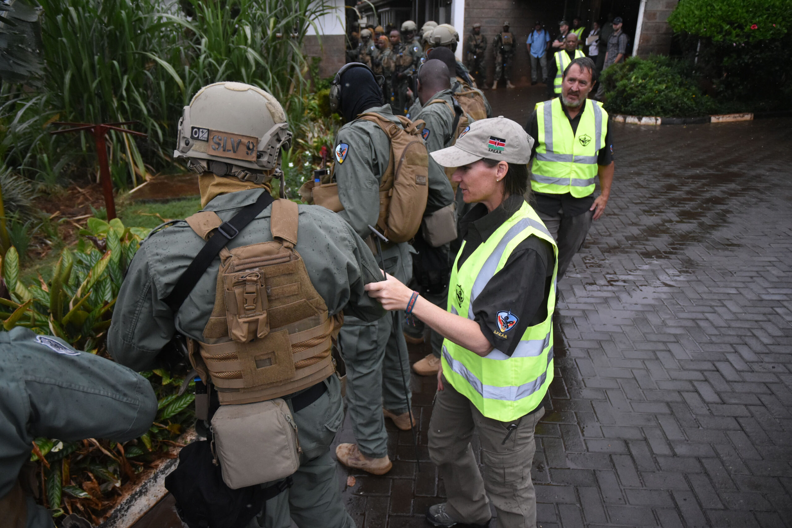 Instructors, acting as safety observers (in yellow vests), from the Department of State Antiterrorism Assistance program (ATA) conduct weapons safety inspections with Kenyan police on October 30, 2021, before the start of a Joint Readiness Exercise to test emergency response during a simulated attack. The Kenyan police are members of the ATA-trained SPEAR (Special Program for Embassy Augmentation Response) team assigned to protect U.S. diplomatic personnel.