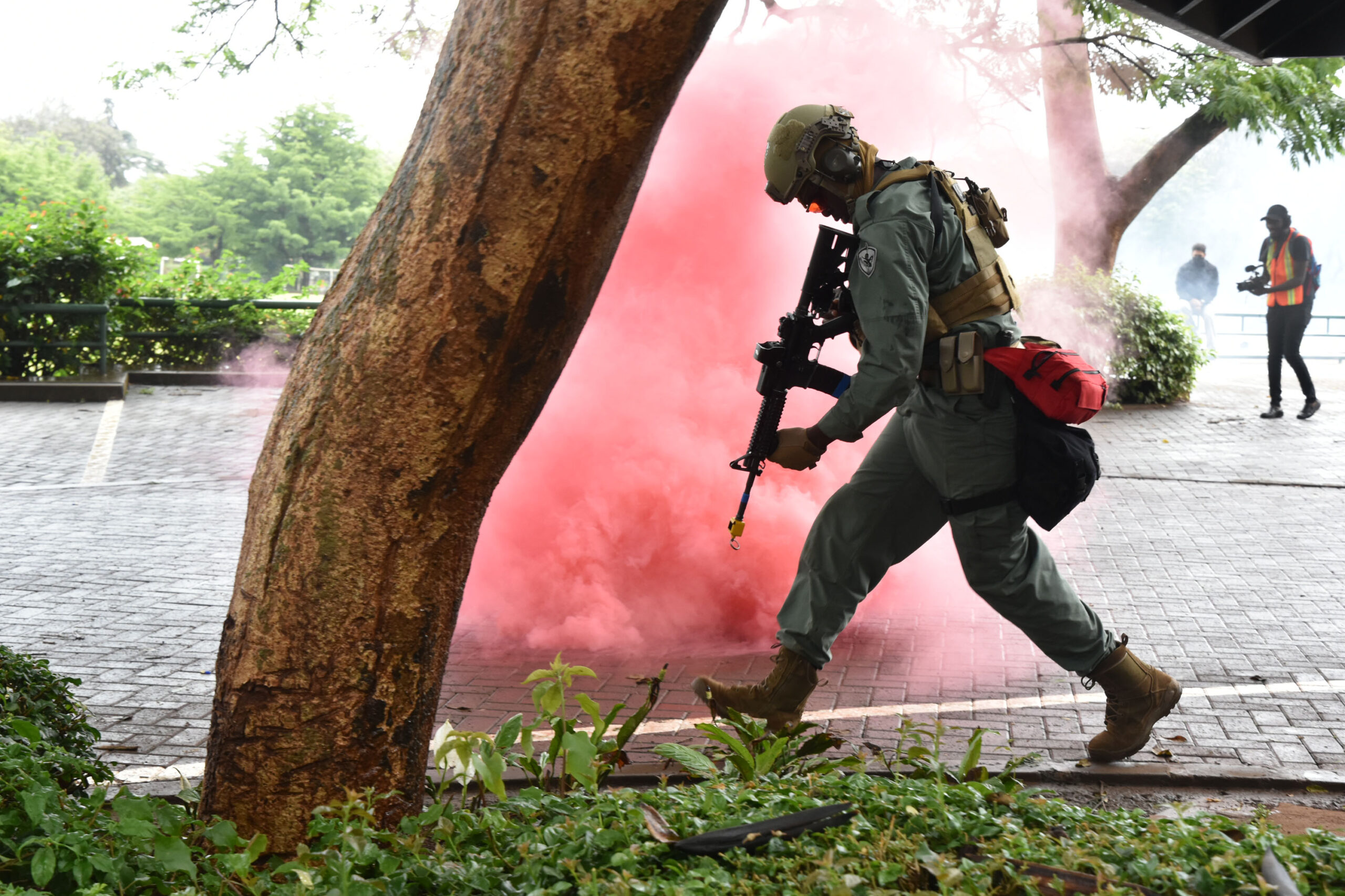 A member of the ATA-trained Kenya SPEAR team runs through smoke at the Rosslyn Academy in Nairobi during a Joint Readiness Exercise on October 30, 2021.