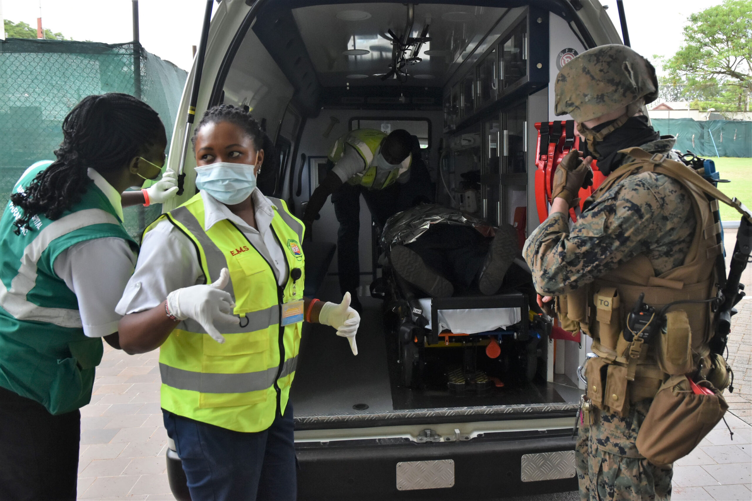 During a training exercise, Kenyan medical authorities load a simulated attack victim aboard an ambulance, assisted by a member of the ATA-trained SPEAR (Special Program for Embassy Augmentation Response) team in Nairobi during a U.S. Embassy Joint Readiness Exercise on October 30, 2021.