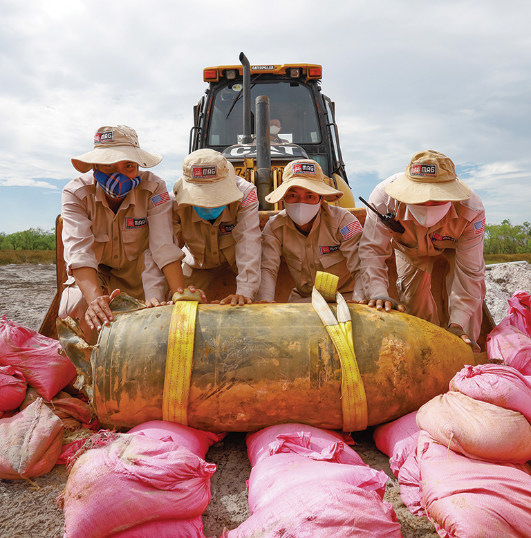 In Vietnam, a team carefully loads UXO in preparation for controlled disposal. [MAG -Mines Advisory Group]