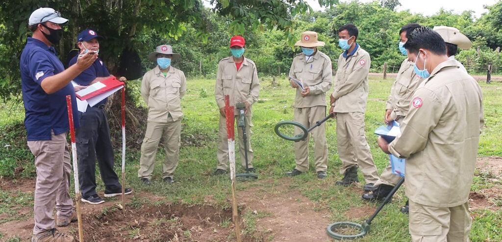 Clearance operators in Laos receive training for using a metal detector. [Tetra Tech]