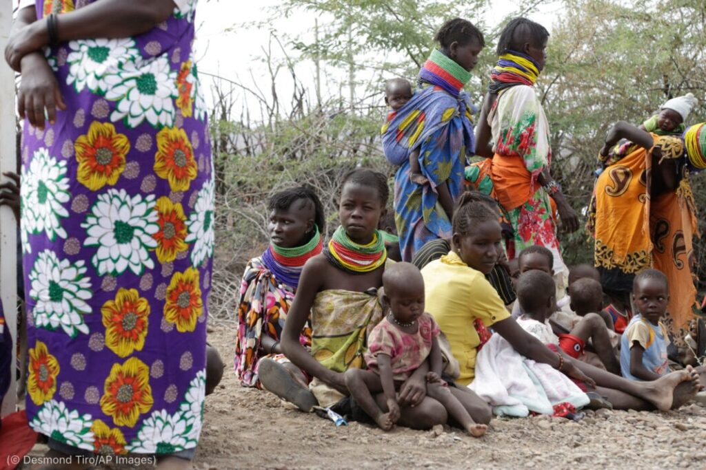 People wait for food distribution by the United States Agency for International Development in Kachoda, Kenya, July 23. (© Desmond Tiro/AP Images)