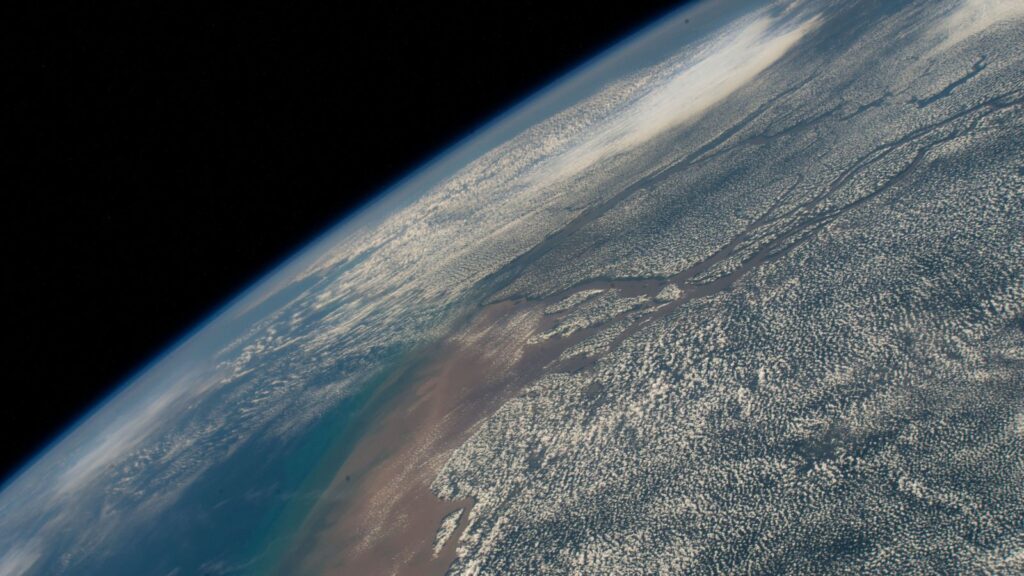 Clouds border the Amazon River as it empties into the Atlantic Ocean in this photograph from the International Space Station taken from 258 miles above Brazil in August 2022. [NASA Johnson image]