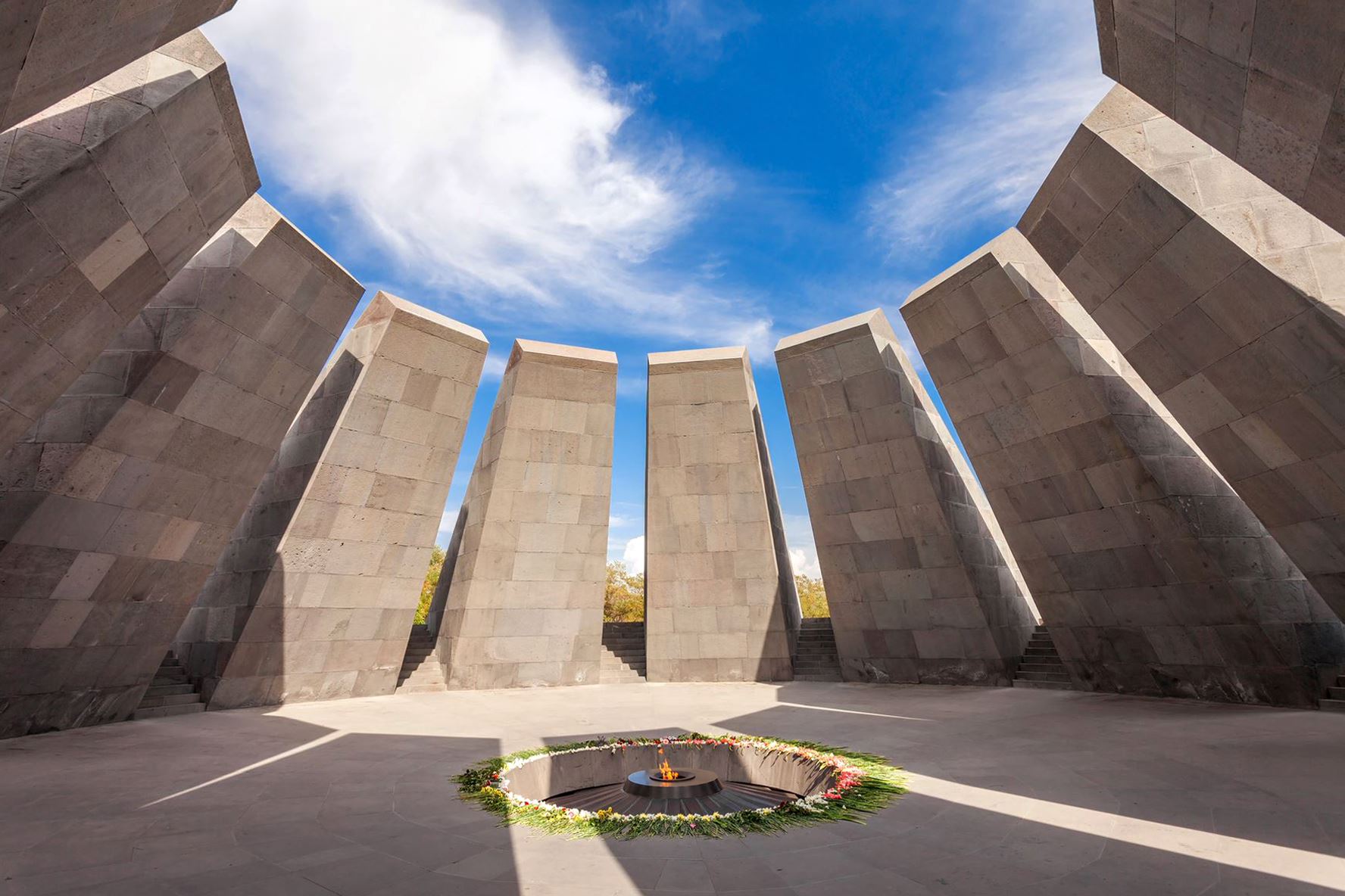 Photo of the Armenian Genocide Memorial complex, beneath a blue sky with white clouds.