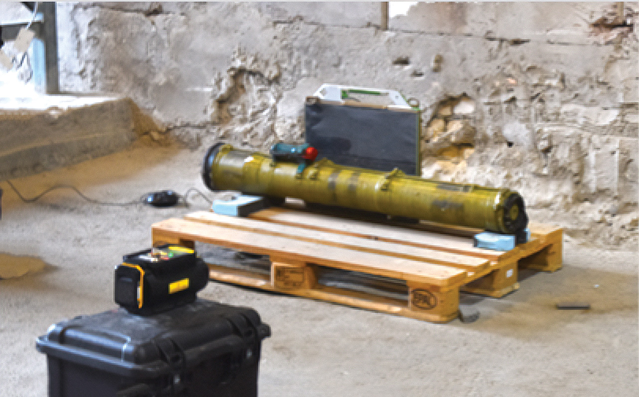 A missile sits on top of a wooden pallet