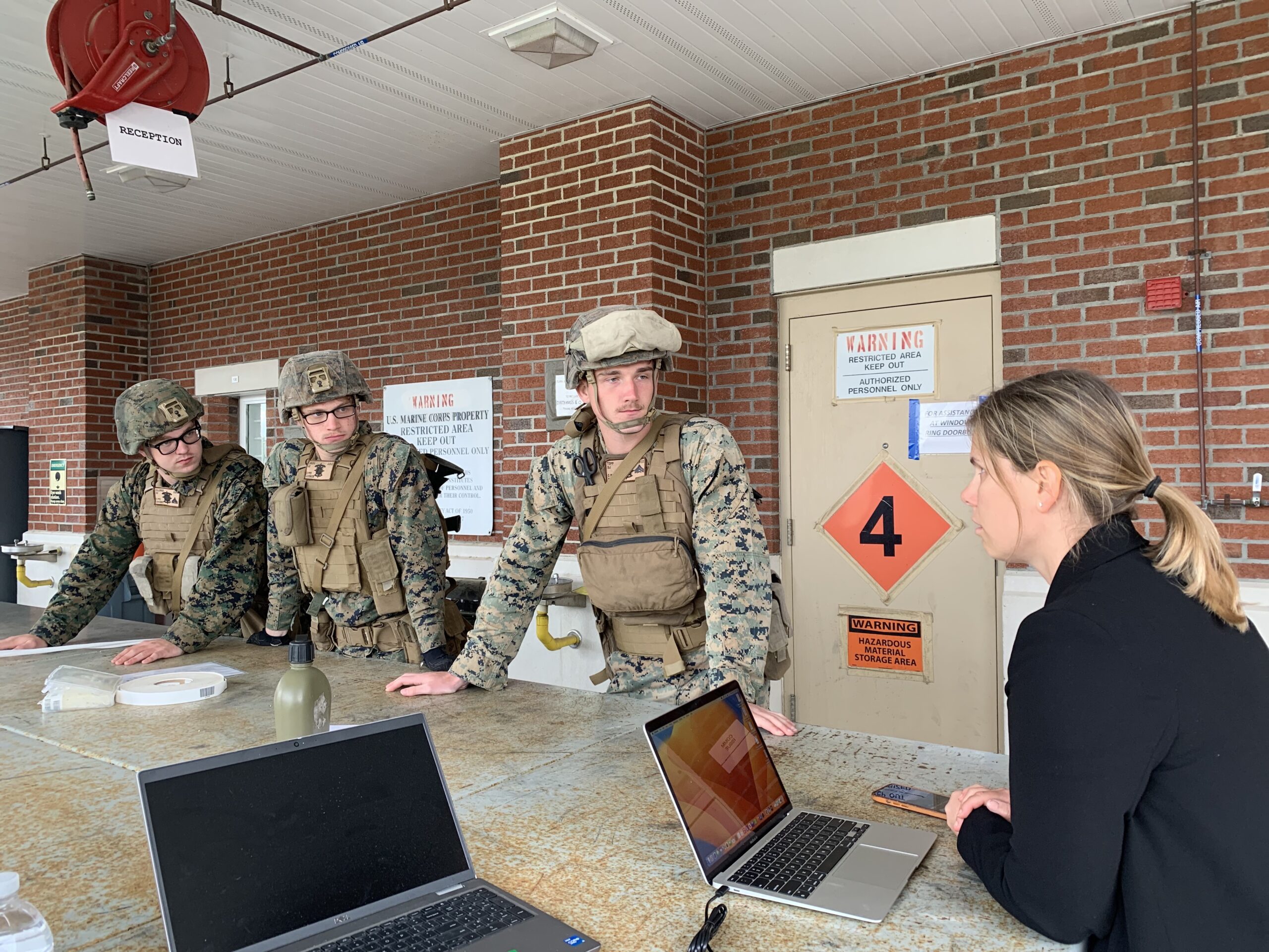    An officer from the State Department’s Bureau of Consular Affairs works with members of the 26th Marine Expeditionary Unit to establish an Evacuation Control Center for U.S. citizens during a training exercise.