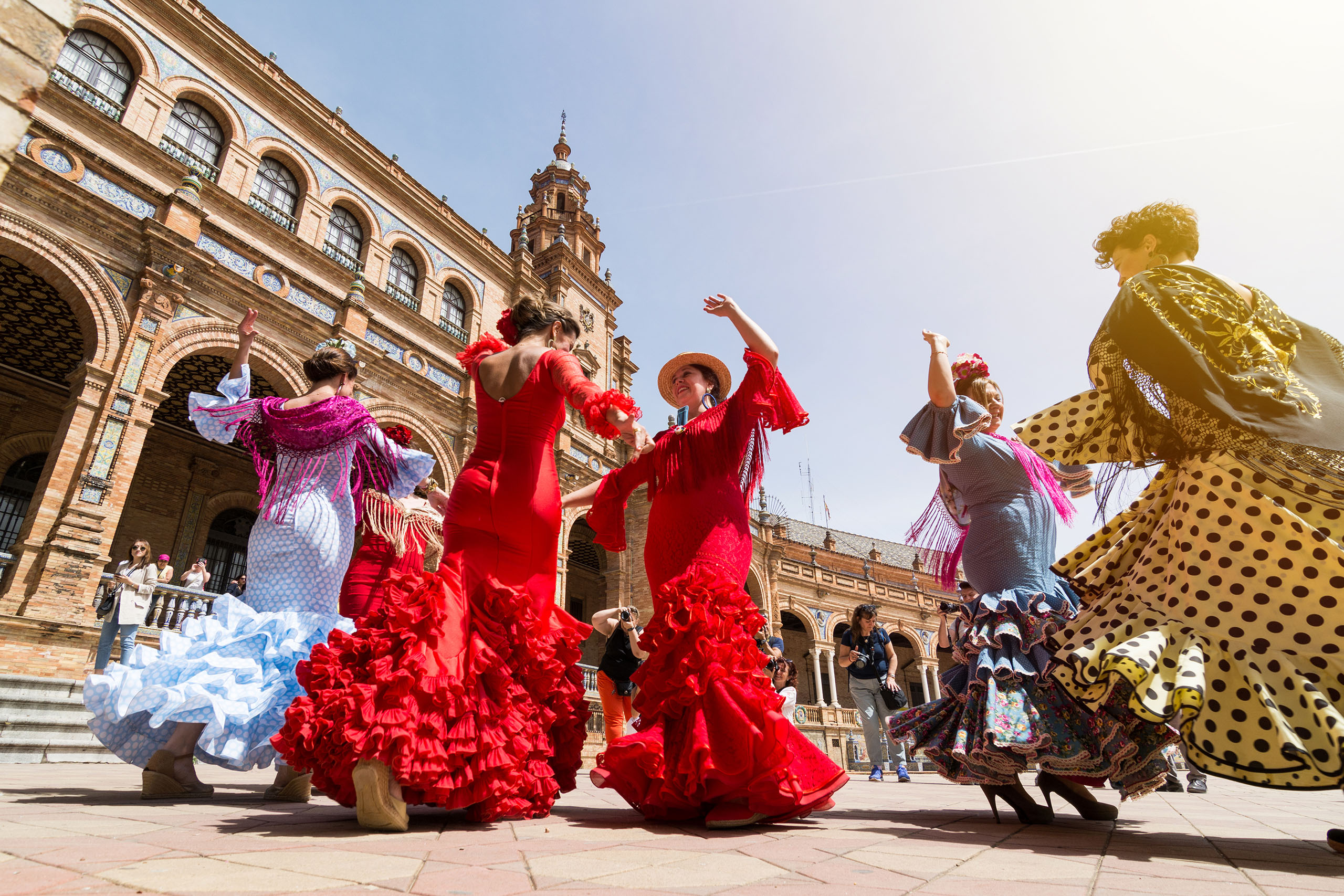 SEVILLE, SPAIN - MAY 2017: Young women dance flamenco on Plaza de Espana
