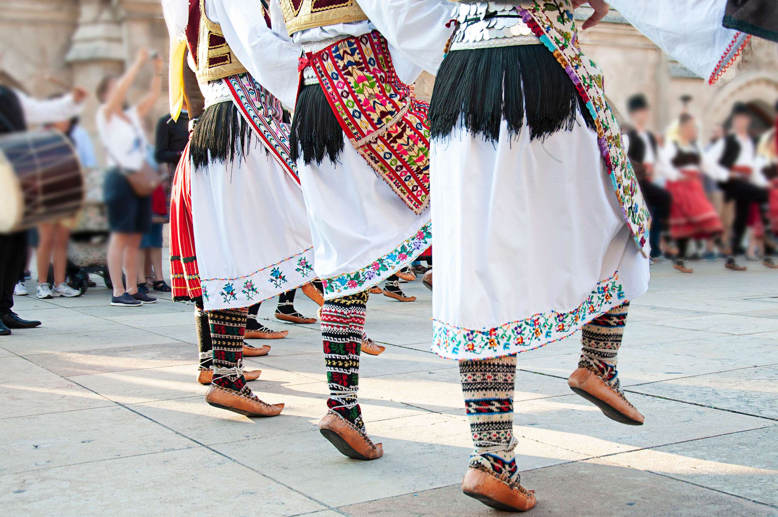 Women wearing one of the traditional folk costume from the Republic of Serbia dancing