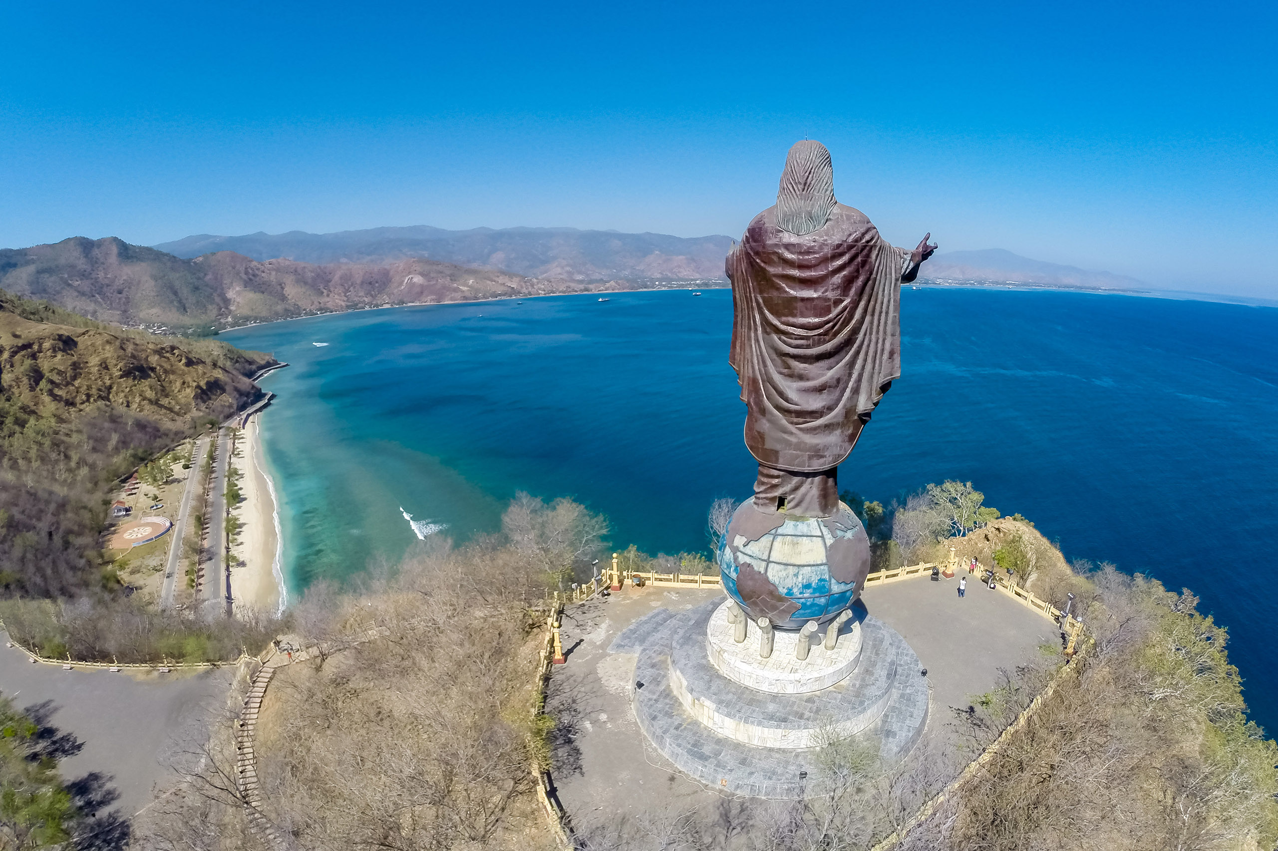 Dili, Timor-Leste - Aug 13, 2015: Aerial view of Cristo Rei of Dili, high statue of Jesus Christ located atop a globe in Dili city, East Timor, on a summit, overlooking the capital of Timor-Leste.