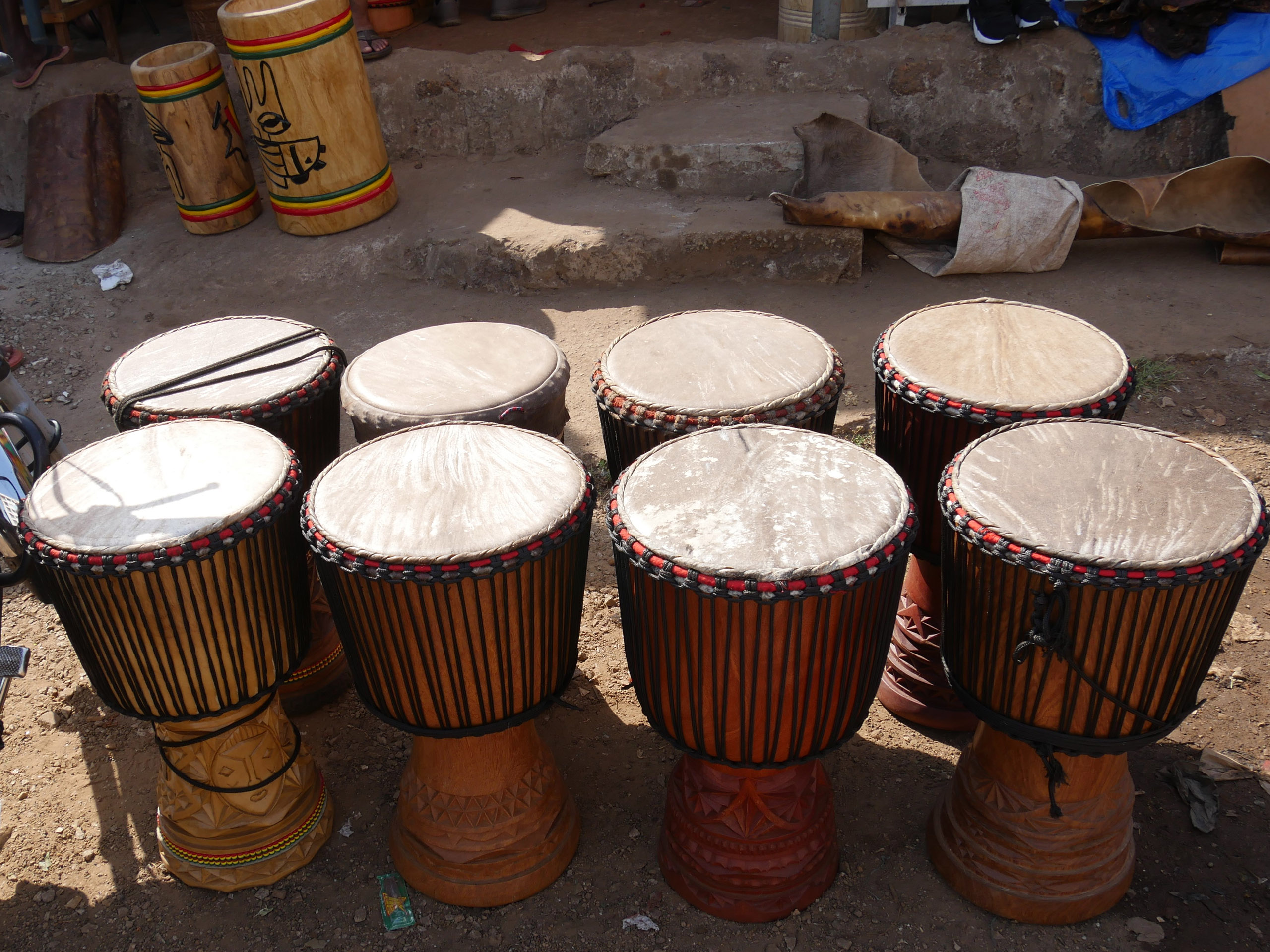 Brand new traditionally hand made Djembes drums sitting outside the shop in Belvedere, Guinea. Belvedere is one of the town's within Conakry, the country's capital.
