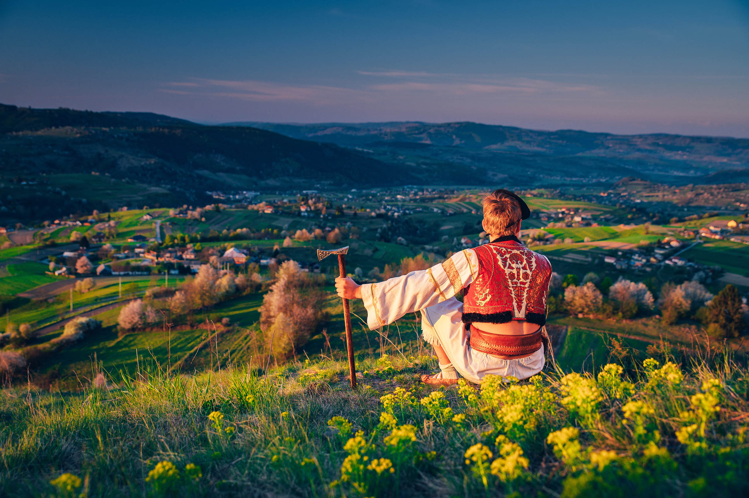 Man in traditional slovak folk dress sitting in spring nature. Hrinova slovakia