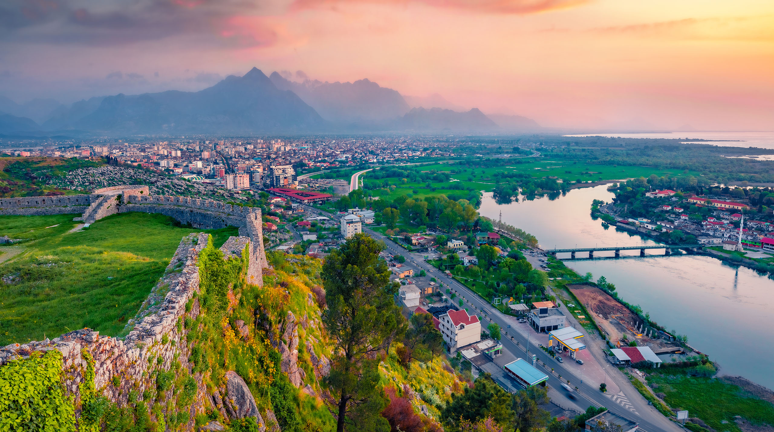 Breathtaking evening view of Rozafa Castle. Astonishing spring cityscape of Shkoder town. Spectacular outdoor scene of Albania, Europe. Traveling concept background.
