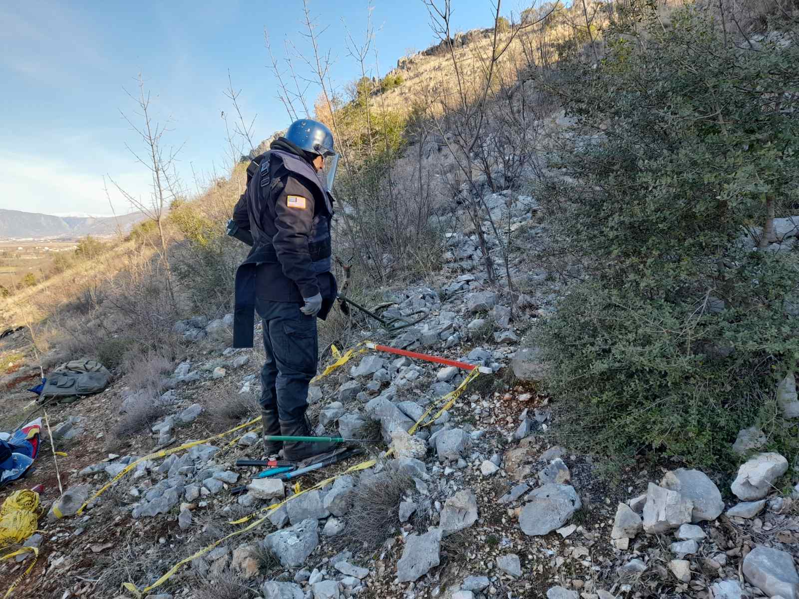 A U.S.-funded deminer surveying a confirmed hazardous area (Photo courtesy of MDDC).
